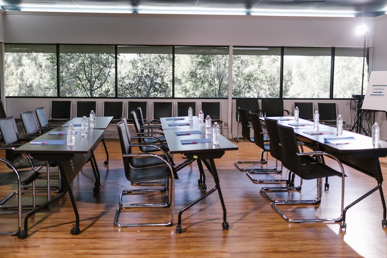 Mastering the First Impression: Your intriguing post title goes here An empty conference room with sleek furniture, ready for a meeting. Bright and professional setting.