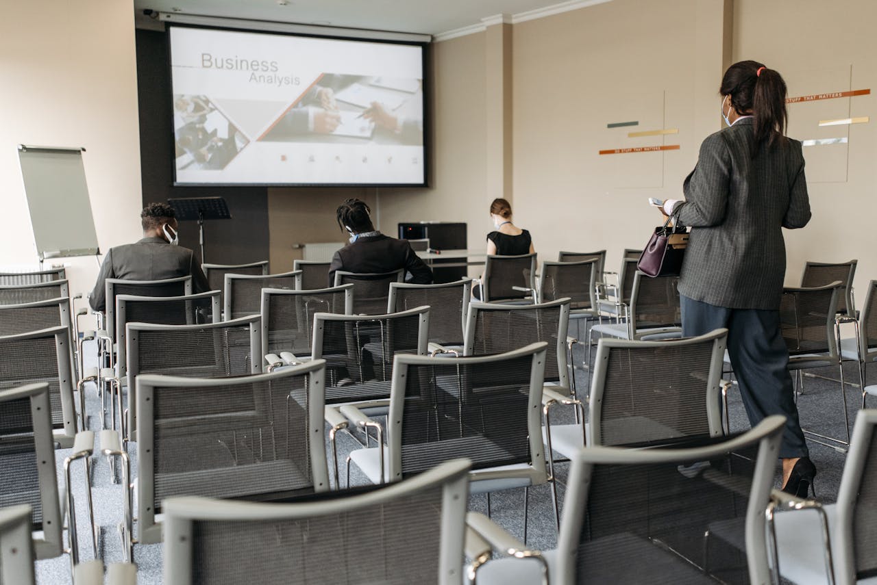 Crafting Captivating Headlines: Your awesome post title goes here Conference room setup for a business seminar, with attendees wearing masks.